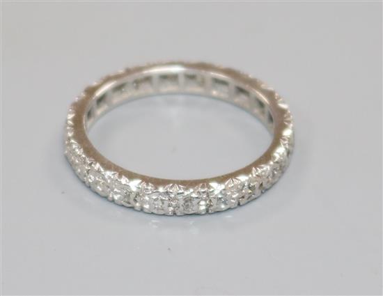A white metal and diamond set full eternity ring, size K/L.